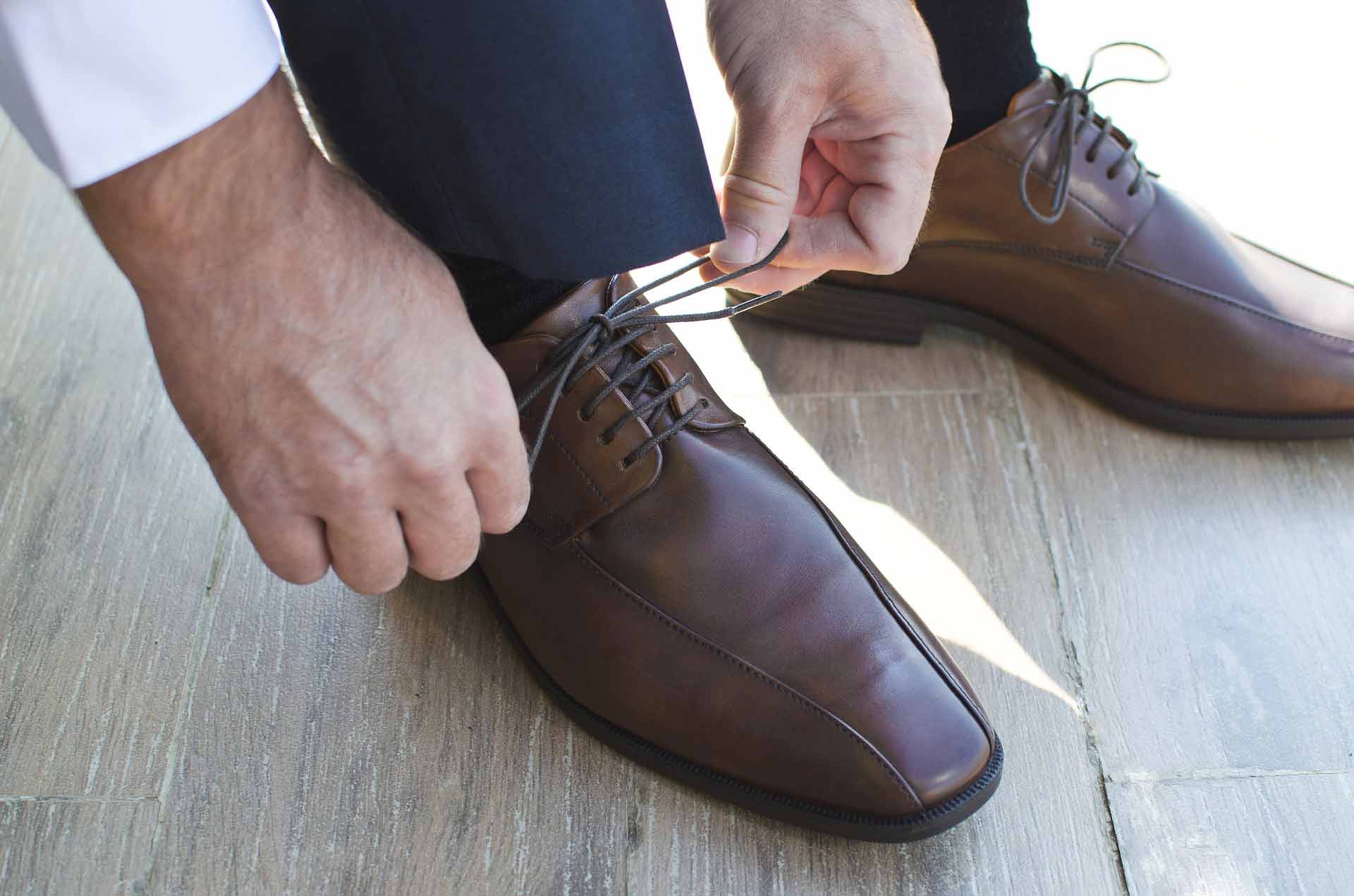 man putting on work shoes: creating work life balance